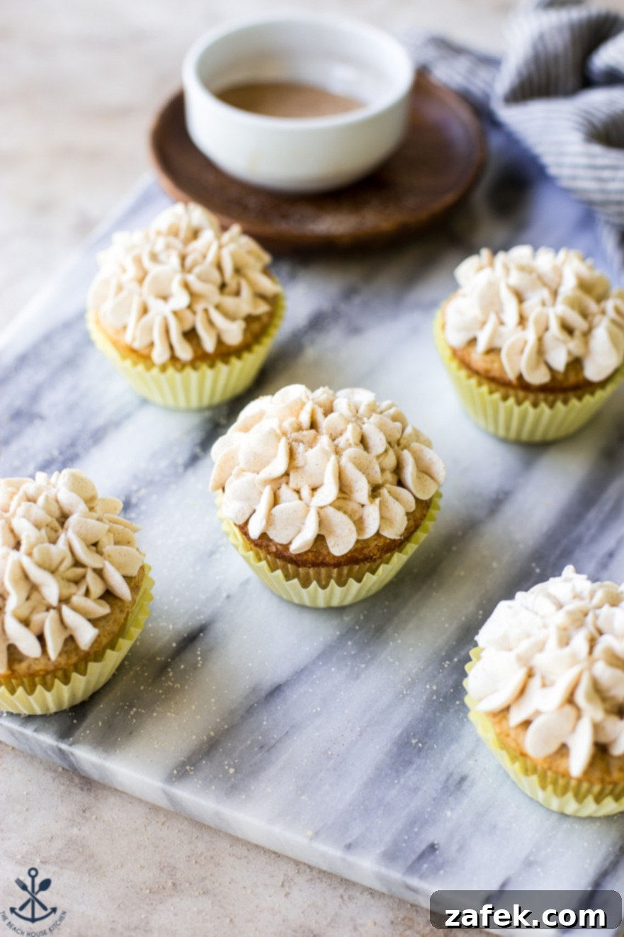 Spiced Snickerdoodle Cupcakes with Cinnamon Buttercream 4 Close-up overhead view of Snickerdoodle Cupcakes with fluffy Cinnamon Buttercream, artfully arranged on a pristine marble board
