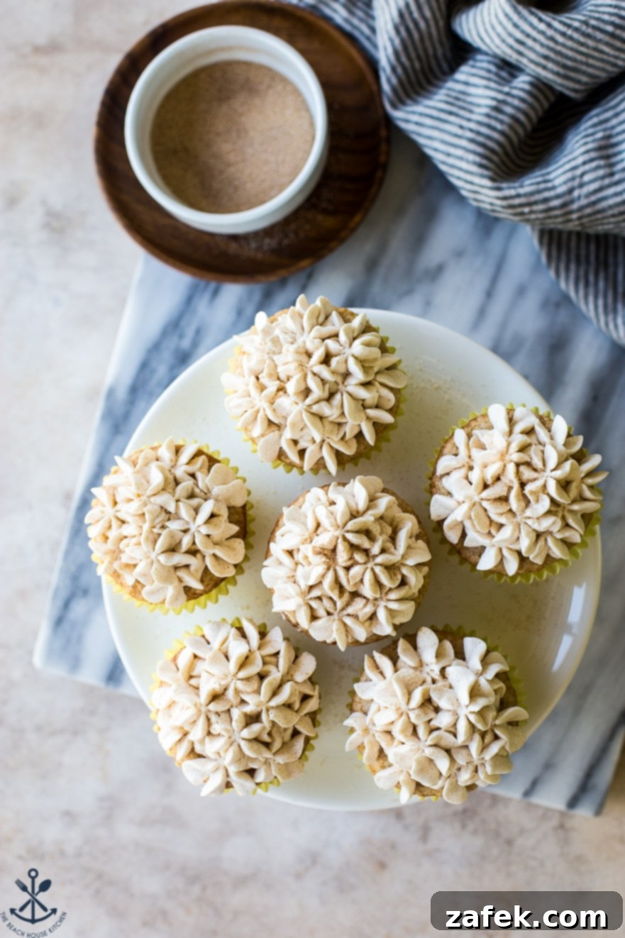 Spiced Snickerdoodle Cupcakes with Cinnamon Buttercream 5 Overhead shot of Snickerdoodle Cupcakes with Cinnamon Buttercream on a white cake plate, ready to be enjoyed