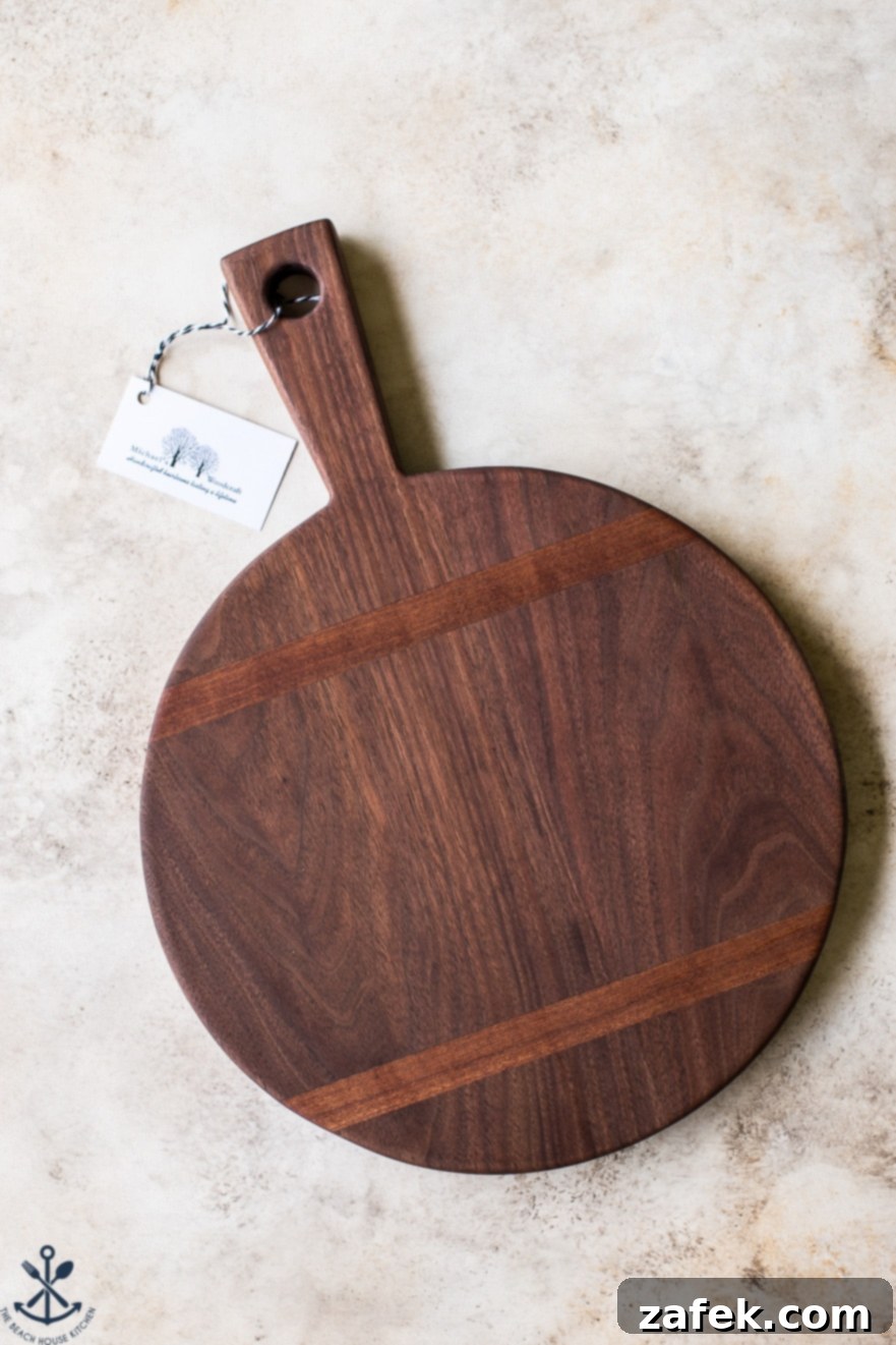 Ultimate Chocolate Chip Banana Bread Waffles 8 An elegant overhead shot of the giveaway prize: a 12-inch round walnut wooden serving board with a sturdy handle and decorative inlays, highlighting its smooth finish and rich wood grain.