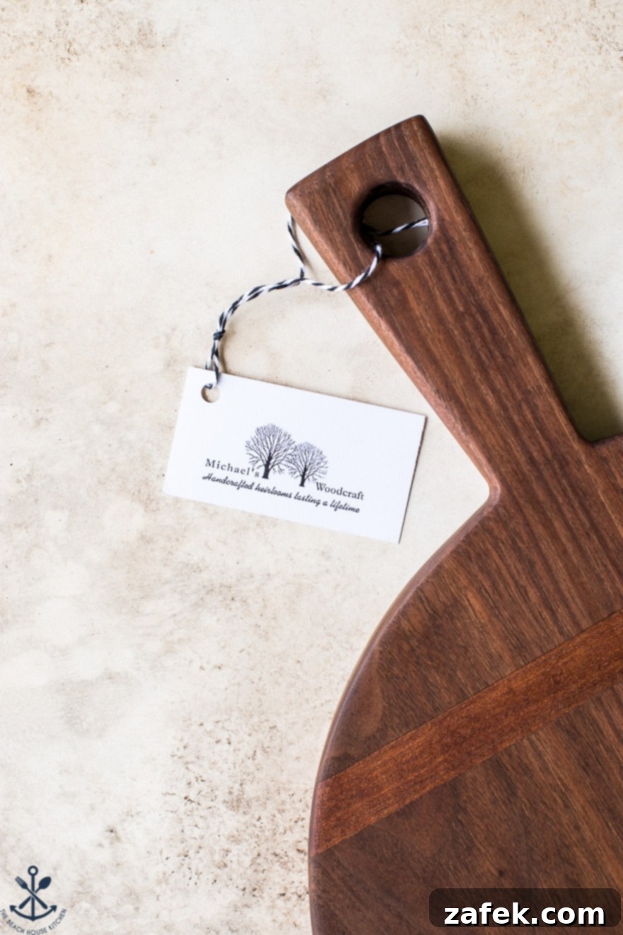 Ultimate Chocolate Chip Banana Bread Waffles 9 Another perspective of the 12-inch round walnut wooden serving board, showcasing its elegant profile, handle, and the subtle beauty of its inlays from a slightly different angle.