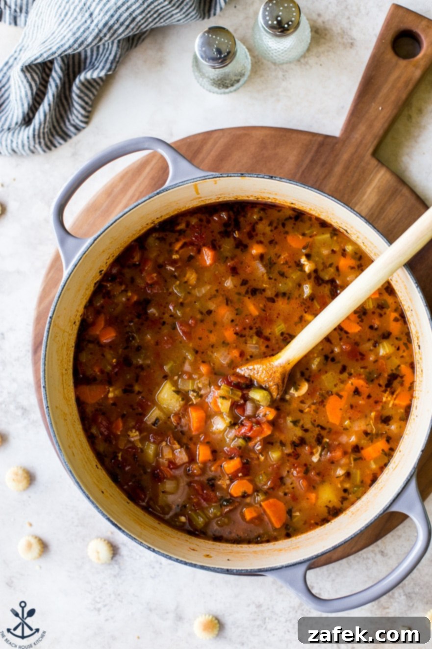 Manhattan's Red Clam Chowder 3 Close-up of a single bowl of Manhattan Clam Chowder, showcasing the rich tomato broth, tender clams, and colorful vegetables.