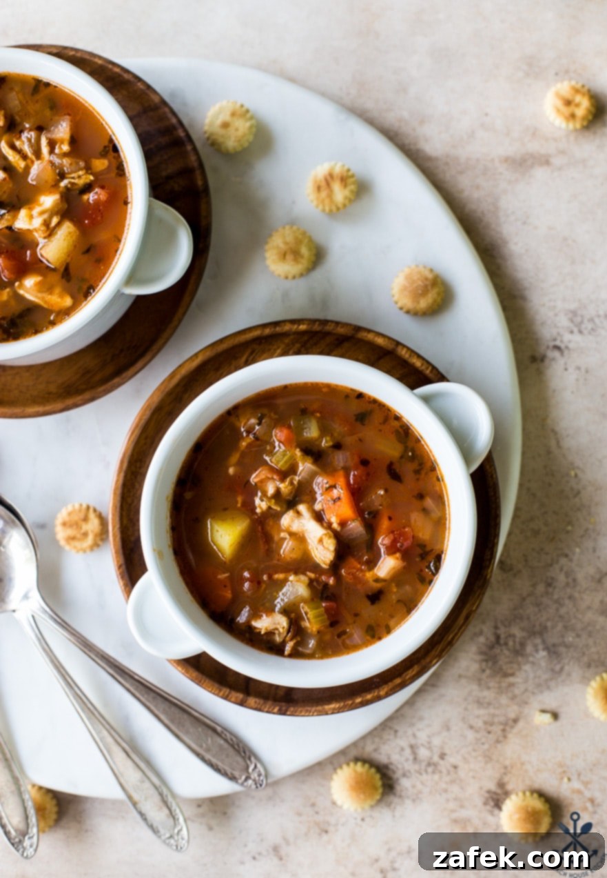 Manhattan's Red Clam Chowder 4 A bowl of Manhattan Clam Chowder with a slice of crusty bread on the side, ready to be enjoyed.