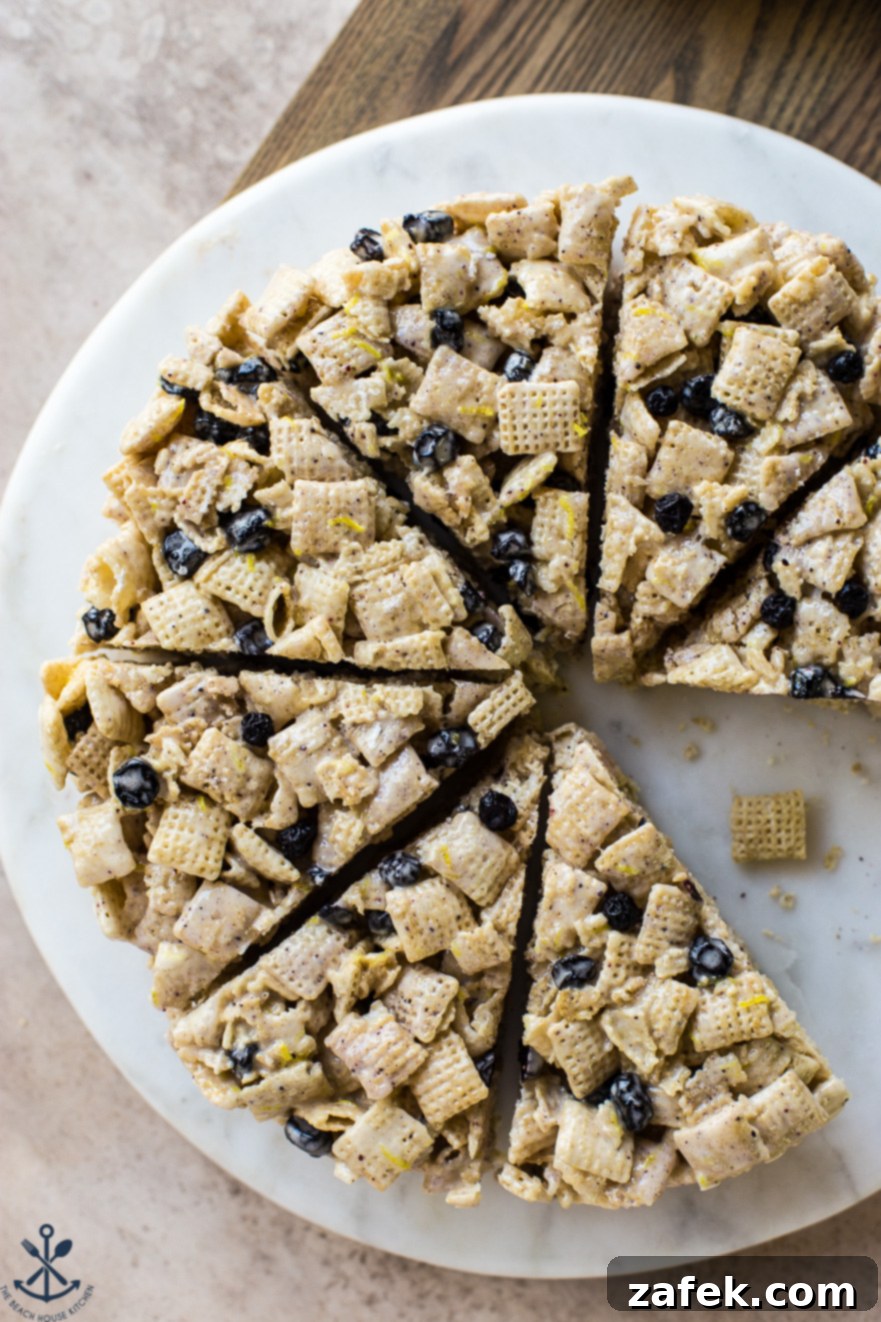 Blueberry Chex Crunch Bars 2 Beautifully cut wedges of Blueberry Chex Krispie Treats arranged on a pristine white round marble board, showcasing their vibrant blueberry specks and inviting texture.