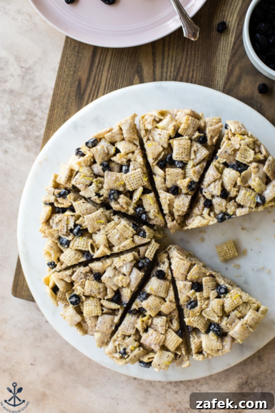 Blueberry Chex Crunch Bars 5 A striking overhead shot of multiple wedges of Blueberry Chex Krispie Treats artfully arranged on a round white marble board, highlighting their golden edges and colorful inclusions.