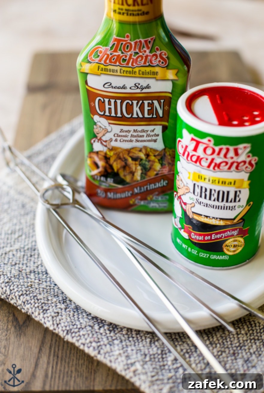 Photo of Tony Chachere's chicken marinade and creole seasoning containers on a white plate with silver skewers