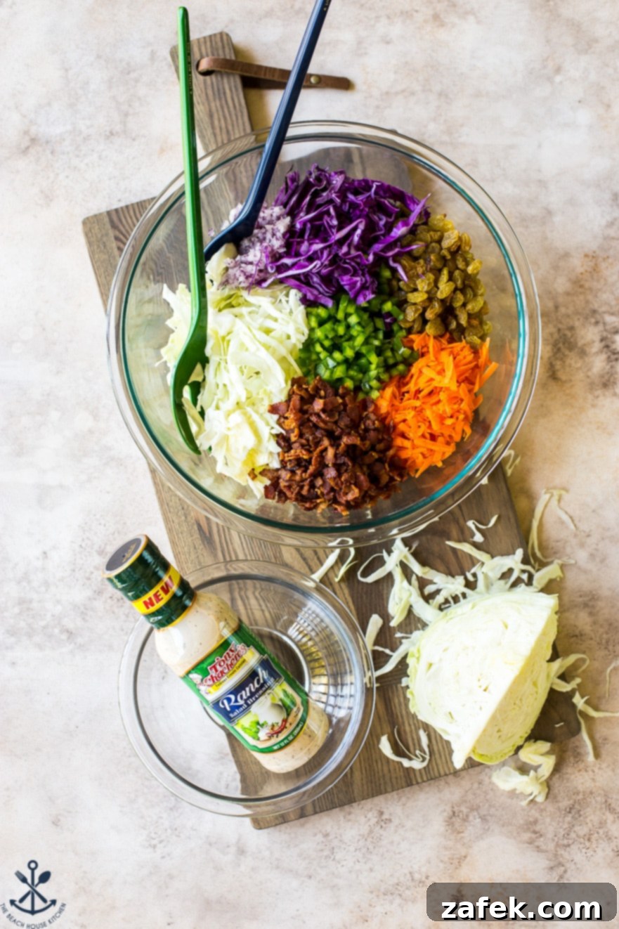 Overhead photo of ingredients for bacon ranch cole slaw in a glass bowl