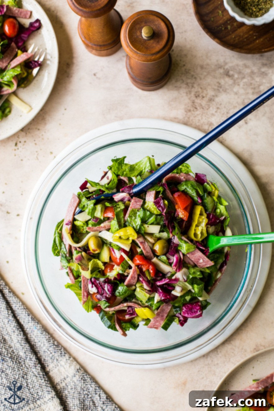 A vibrant Italian Chopped Salad, perfect for gatherings, in a large glass bowl ready to be served
