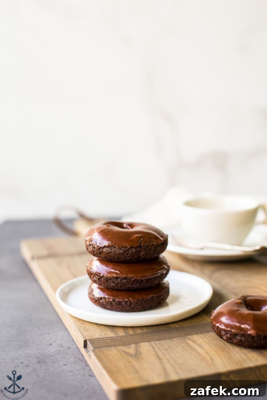 Baked Mocha Donuts 4 Another enticing view of a stack of three chocolate coffee donuts, highlighting the decadent glaze and appealing presentation.
