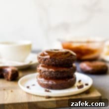 Baked Mocha Donuts 10 Appetizing photo of a stack of three cocoa coffee baked donuts, featured as the main recipe image.