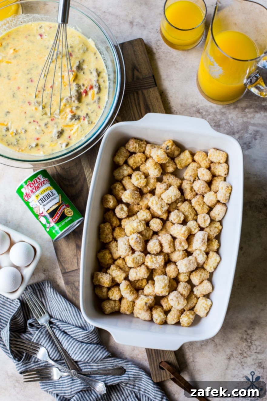 Creole Breakfast Casserole 3 Overhead photo of white baking dish filled with tater tots