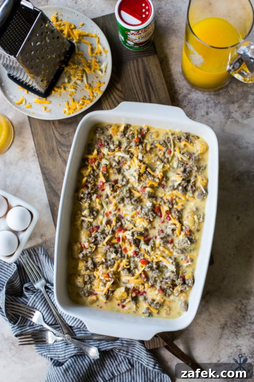 Creole Breakfast Casserole 4 Overhead photo of pre baked Creole Breakfast Egg Bake with Sausage and Potatoes in a white baking dish