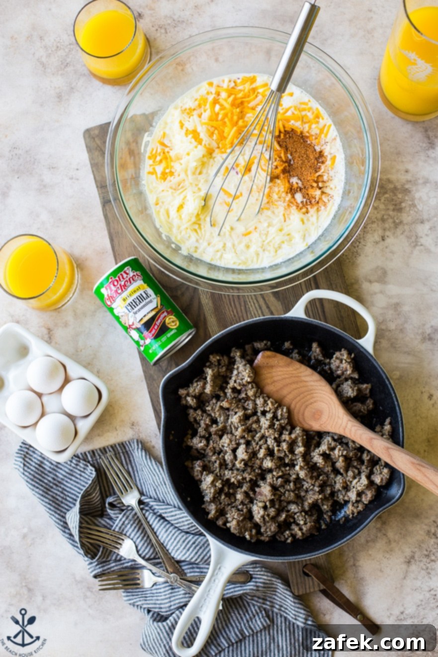 Creole Breakfast Casserole 7 Overhead photo of ingredients for Creole Breakfast Egg Bake with Sausage and Potatoes on a wooden board