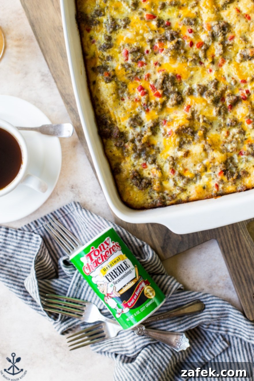 Creole Breakfast Casserole 8 Up close over head photo of Creole Breakfast Egg Bake with Sausage and Potatoes in a white baking dish with a can of Tony Chachere's Original Creole seasoning