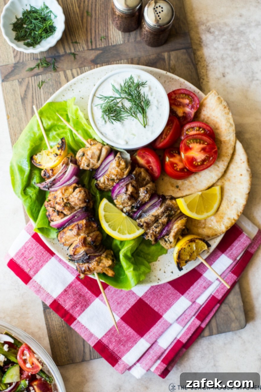 Overhead photo of Chicken Souvlaki Skewers with Tzatziki Sauce on a plate