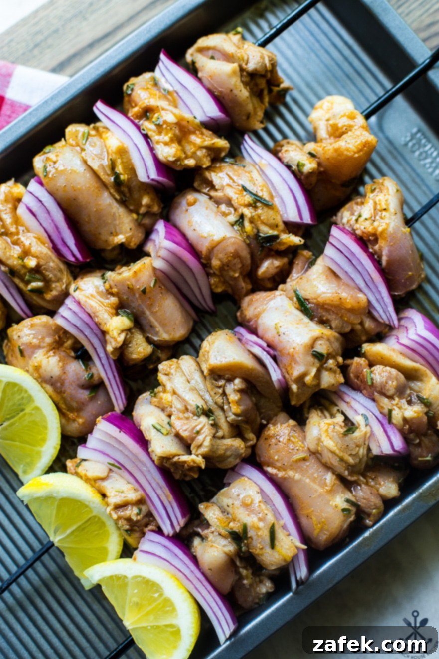 Pre-grilled Chicken Souvlaki Skewers on a baking sheet