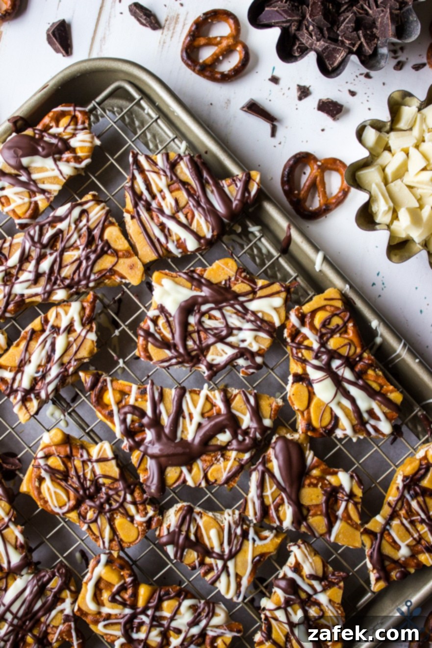 Overhead photo of pretzel toffee pieces cooling on a wire rack placed over a baking sheet, ensuring even air circulation.