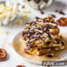 A close-up shot of individual pretzel toffee pieces, perfectly golden and drizzled with chocolate.
