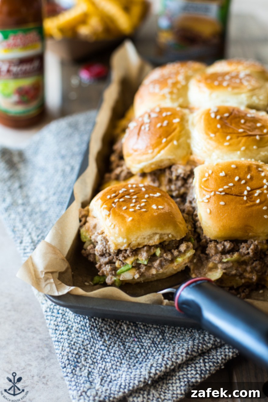 A tray of Tony's Baked Cheeseburger Sliders lined with parchment paper, ready to be served