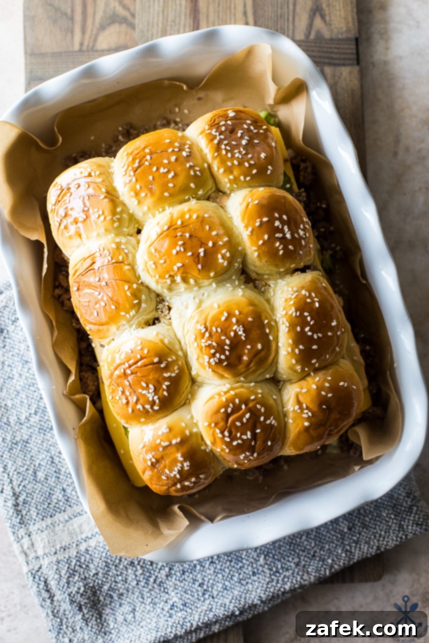 An overhead photo of Tony's Baked Cheeseburger Sliders arranged in a white baking dish, fresh from the oven