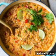 Overhead photo of skillet filled with cheesy queso fiesta rice