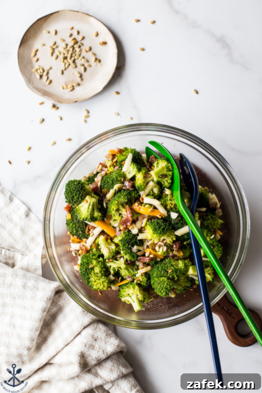 Overhead photo of classic broccoli salad with bacon in a glass bowl, showcasing vibrant colors