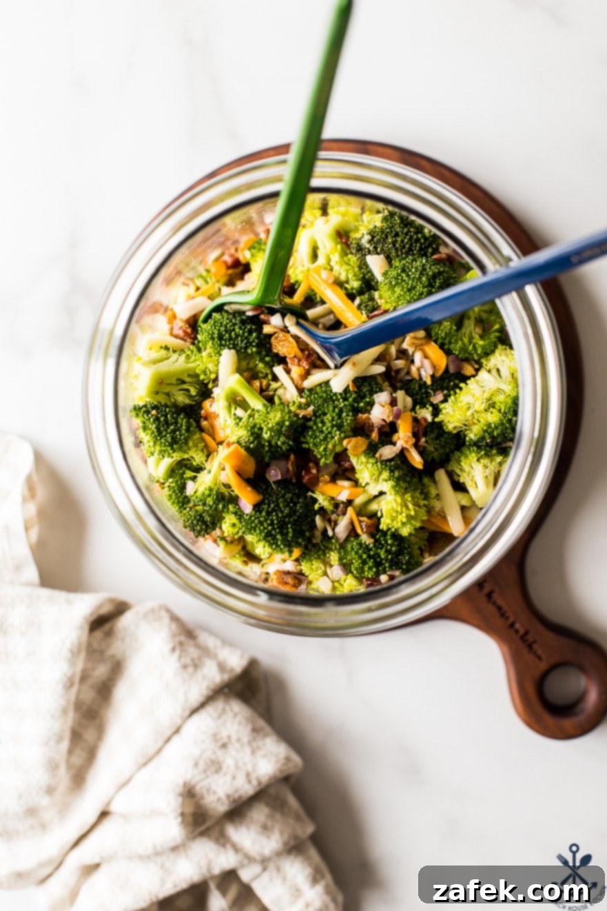 Overhead photo of classic broccoli salad with bacon in a glass jar, ready for transport
