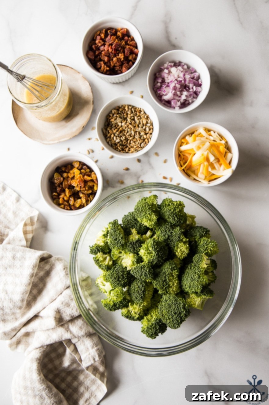 Overhead photo of individual ingredients for classic broccoli salad with bacon in separate bowls, ready for mixing