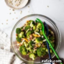 Overhead photo of classic broccoli salad with bacon in a glass bowl, ready to serve