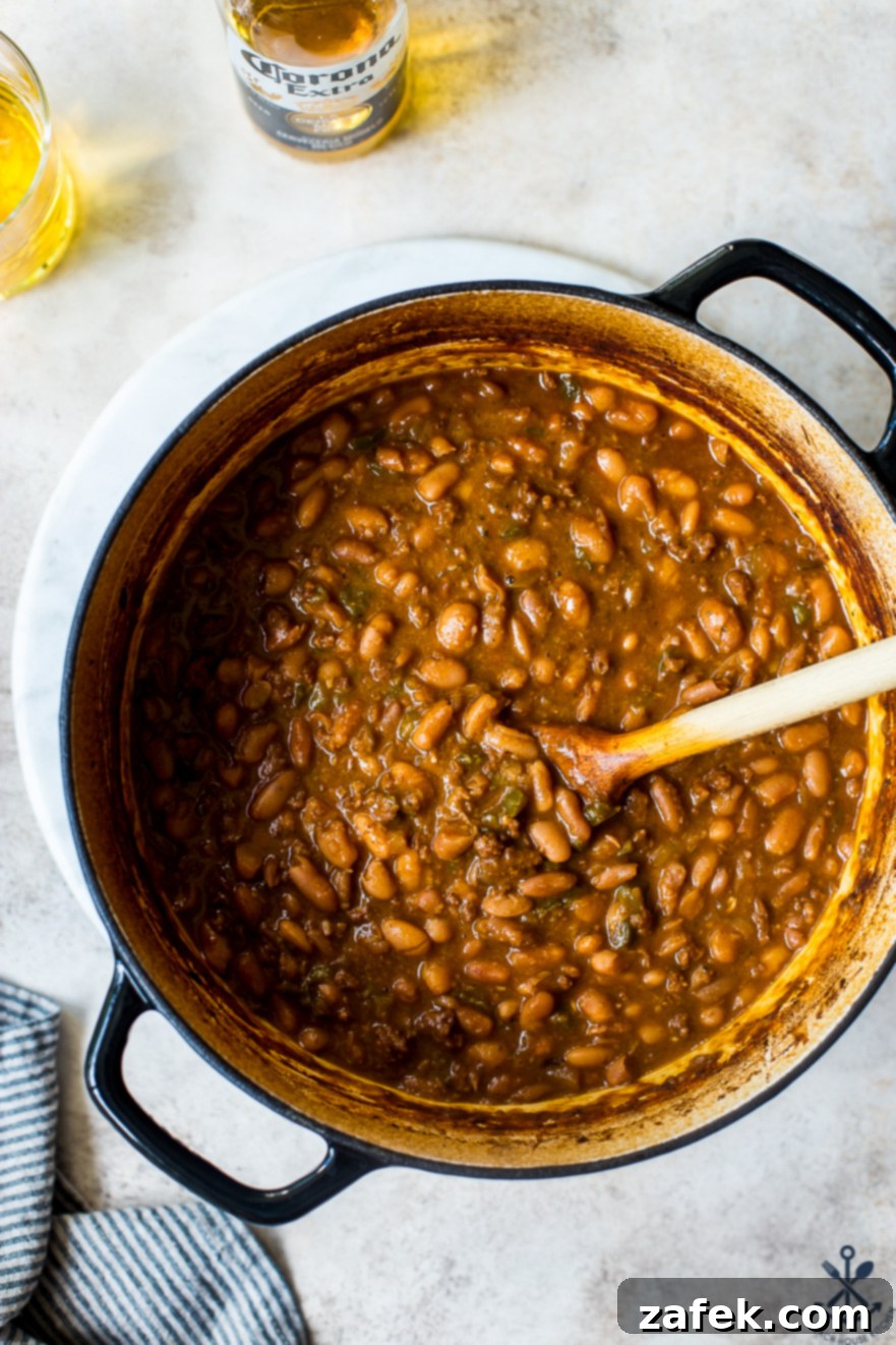 Overhead photo of a serving of Mexican Baked Beans in a rustic bowl