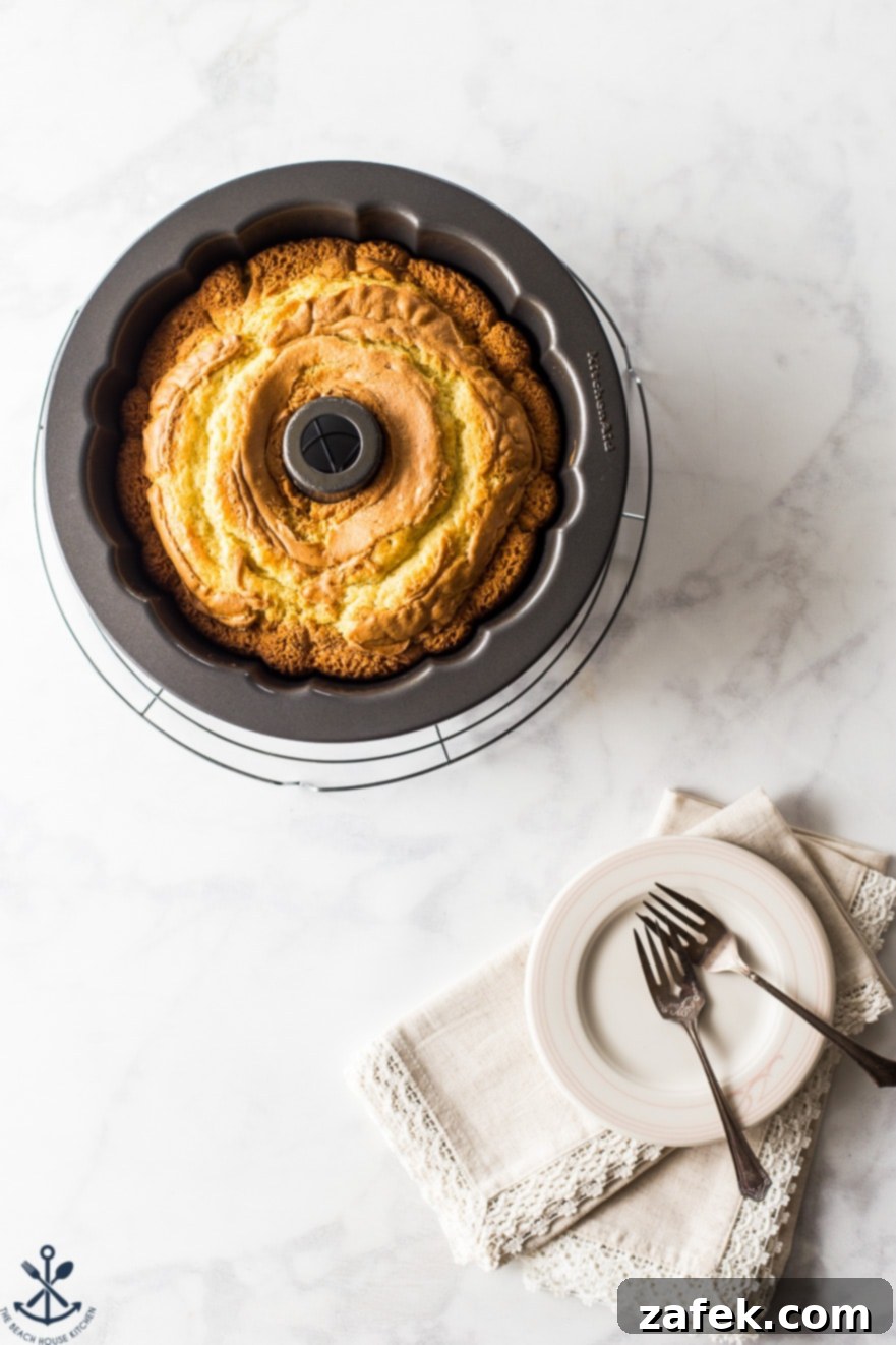 A top-down view of the beautifully presented Easy Twinkie Bundt Cake, with a generous dusting of powdered sugar, highlighting its elegant bundt shape.