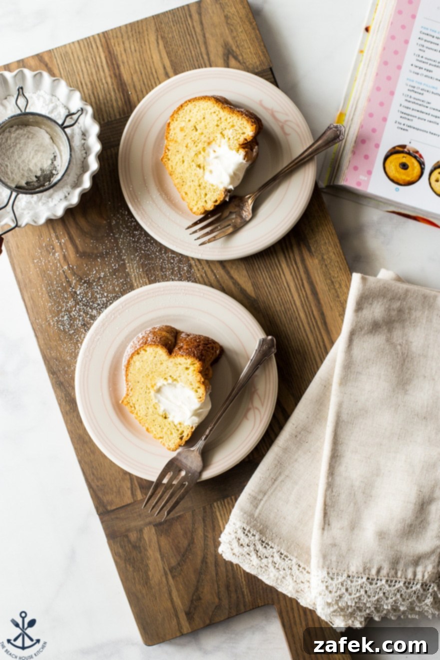 Overhead photo of two dishes, each with a slice of the Easy Twinkie Bundt Cake, artfully arranged on a rustic wooden board, ready to be enjoyed.