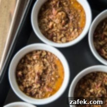 Spiced Pumpkin Custards with Gingersnap Crumble 10 Pumpkin Custards with Gingersnap Crumble in white ramekins in a roasting pan