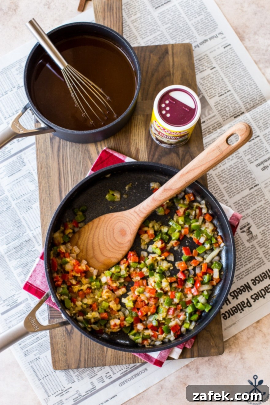Bayou Poutine 8 Overhead photo of green and red pepper and onion in a skillet