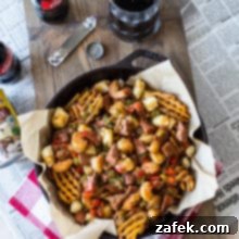 Bayou Poutine 10 Overhead photo of Cajun poutine in a skiller on a wooden board