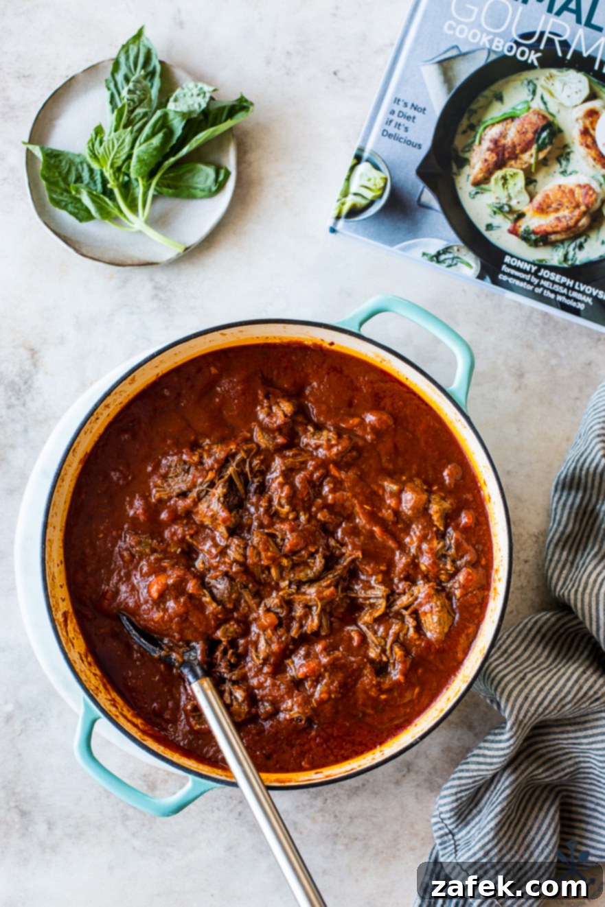 Unforgettable Short Rib Ragù Unmissable Giveaway 2 A Dutch oven brimming with luscious Short Rib Ragù, garnished with fresh basil, ready to be served as the ultimate comfort food.