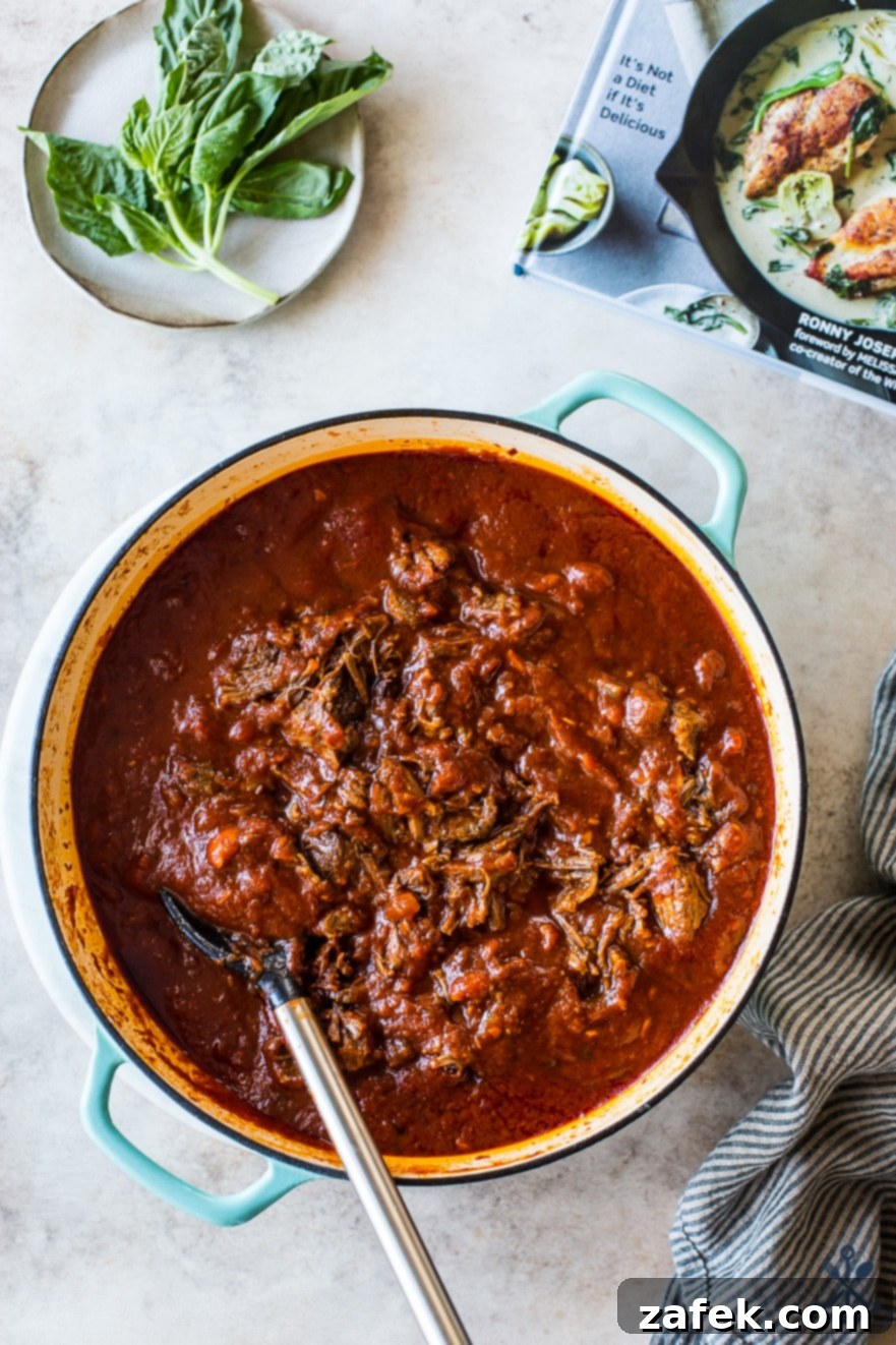 Unforgettable Short Rib Ragù Unmissable Giveaway 4 Another enticing overhead photo showcasing the rich, deep colors of the Short Rib Ragù in a heavy Dutch oven, promising warmth and flavor.