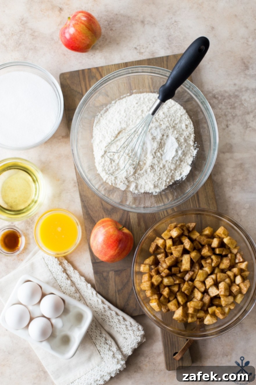 Old Fashioned Apple Spice Cake 12 An inviting overhead photograph displaying all the fresh ingredients meticulously laid out to prepare the Jewish Apple Cake, including apples, flour, sugar, and spices.
