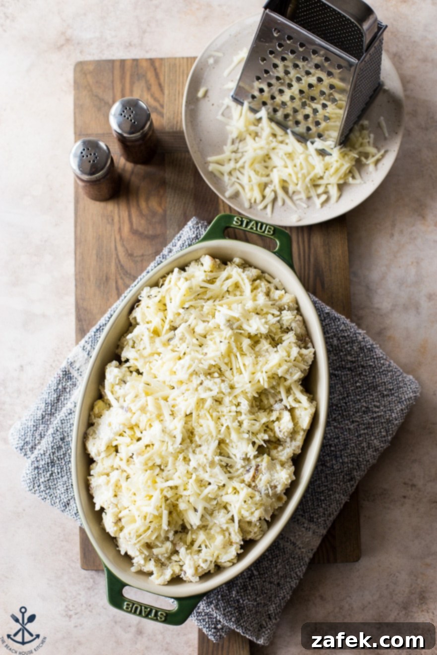 Overhead photo of prebaked potatoes in an oval dish
