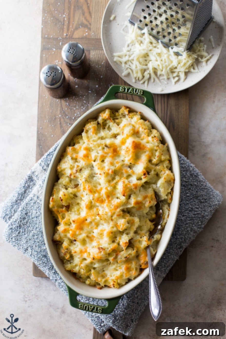Overhead photo of cheesy potatoes in an oval dish