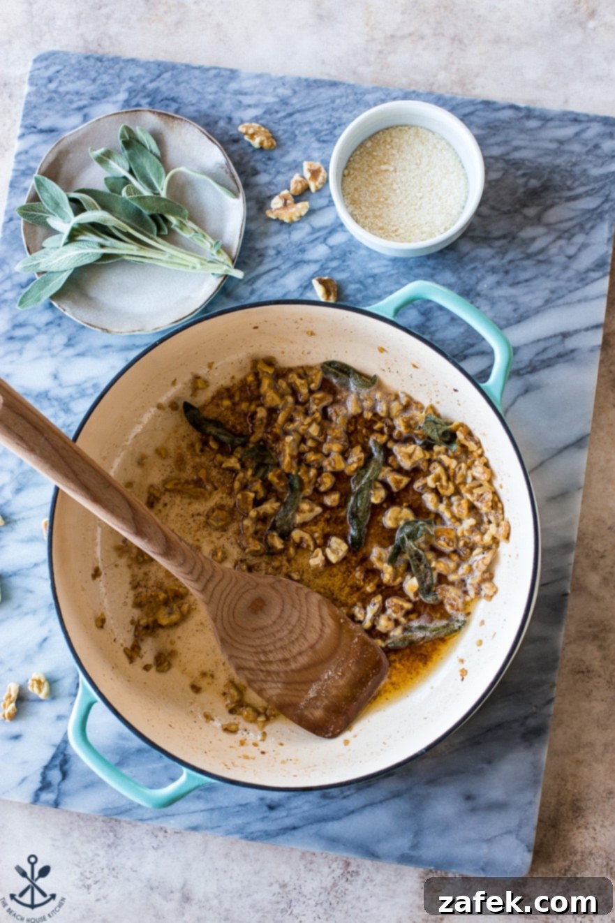 Sage-Kissed Gnocchi with Toasted Walnut Brown Butter 4 Overhead photo of pot filled with walnuts and sage leaves on a marble board