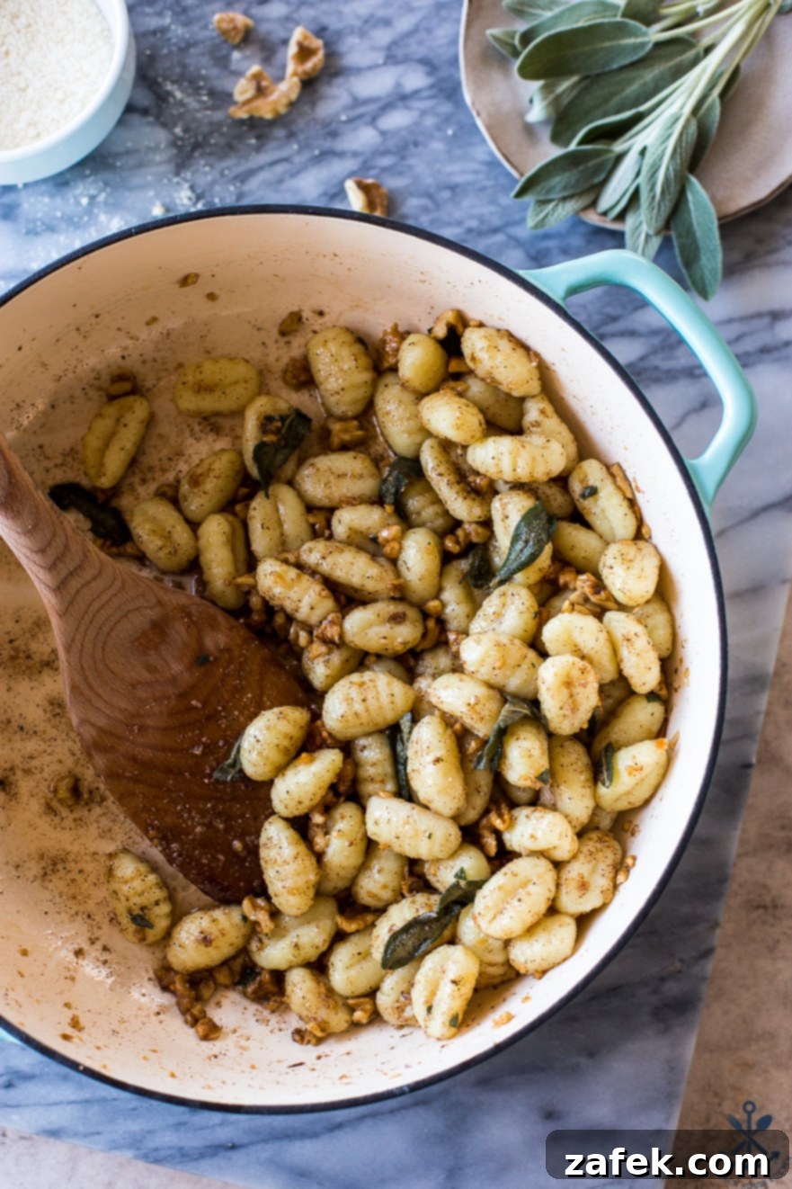 Sage-Kissed Gnocchi with Toasted Walnut Brown Butter 6 Up close overhead photo of a pot filled with Gnocchi with Walnut Brown Butter Sage Sauce