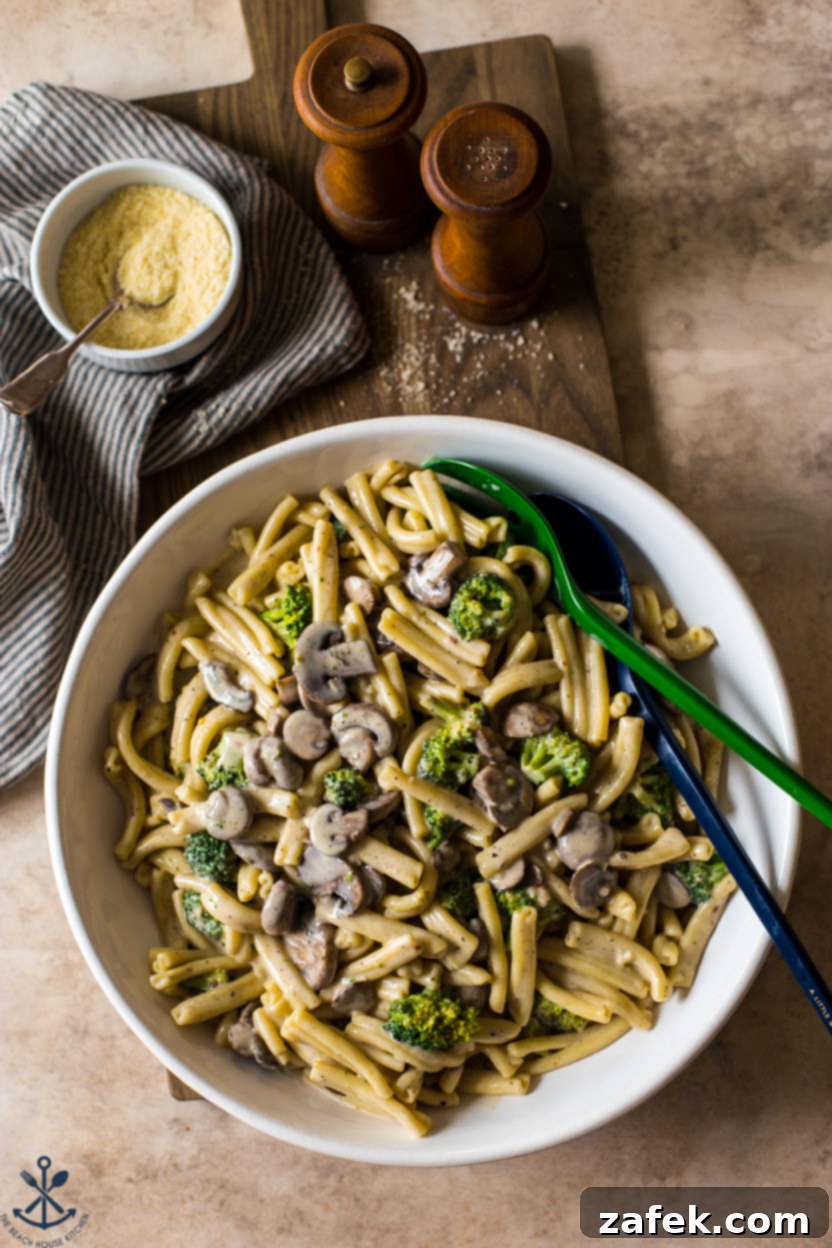 Creamy Garlic Pasta with Broccoli and Mushrooms 7 Overhead photo of a serving platter generously filled with Creamy Garlic Broccoli Mushroom Pasta, garnished with fresh parsley and ready to be enjoyed.