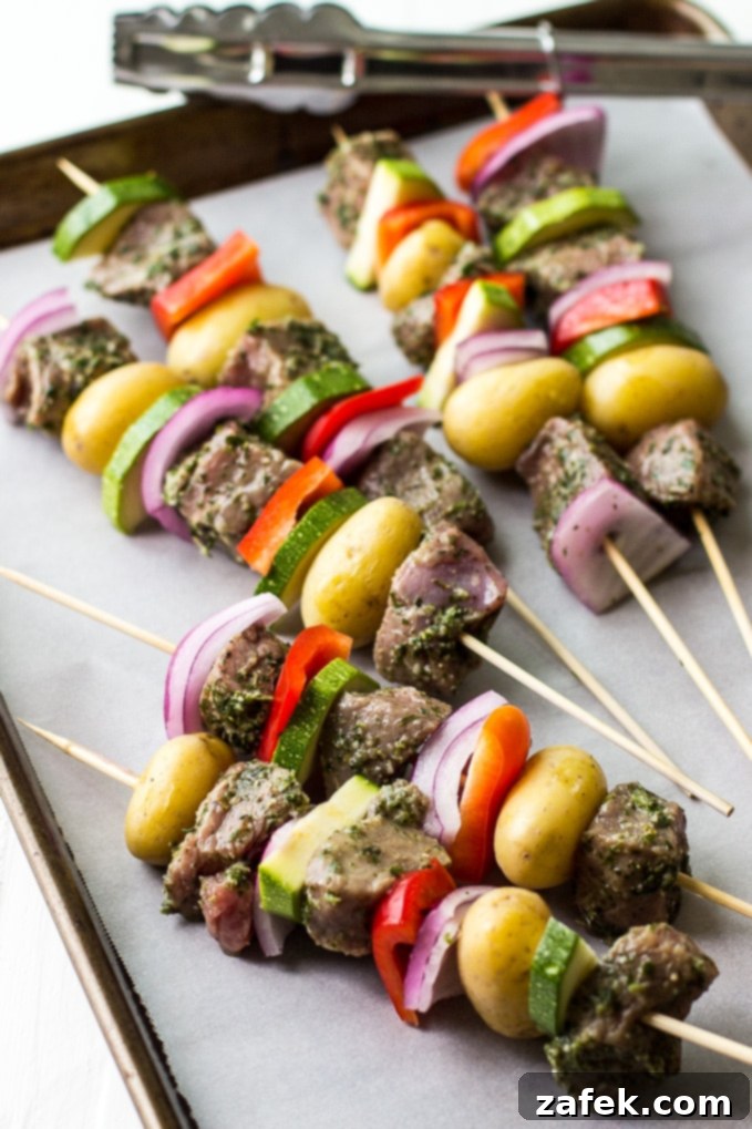 Grilled steak skewers served with a side of chimichurri