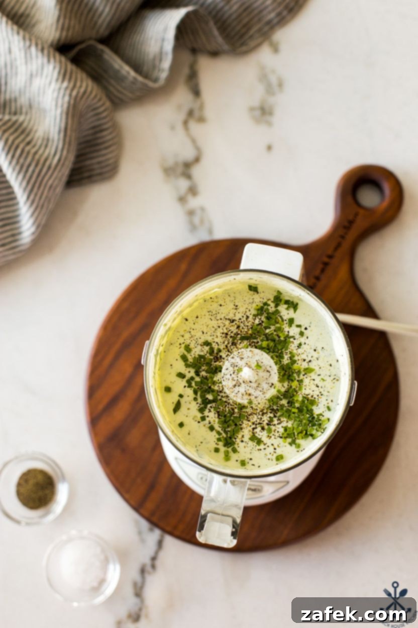 Zesty Green Goddess Greek Chickpea Salad 5 Overhead photo of a small food processor filled with a green goddess dressing