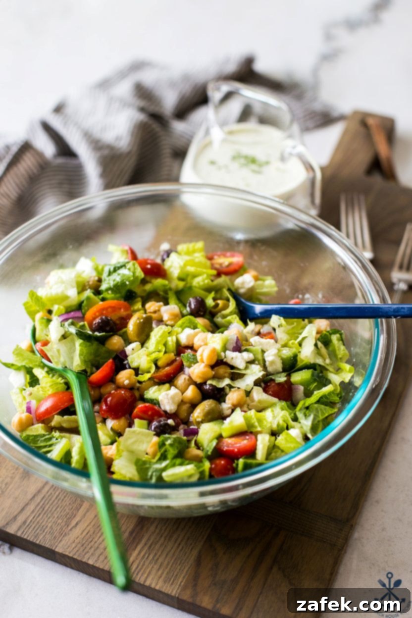 Zesty Green Goddess Greek Chickpea Salad 6 A Greek Chickpea Salad with Green Goddess Dressing in a glass bowl