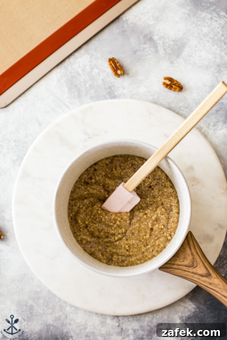 Overhead photo of a small saucepan containing the pecan and coconut cookie mixture before baking