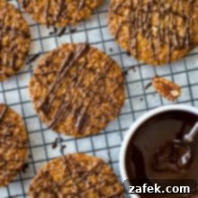 Freshly baked Pecan Coconut Lace Cookies arranged on a wire rack