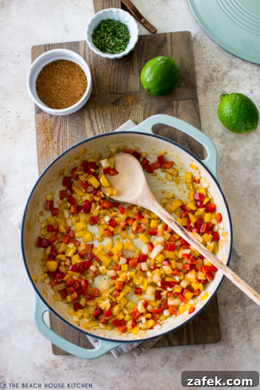 Overhead photo of a skillet of chopped red and yellow peppers