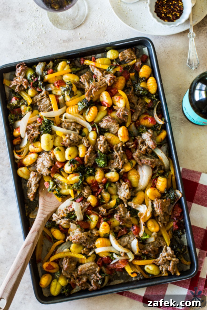 Another enticing overhead view of the Sheet Pan Gnocchi with Italian Sausage, Broccoli Rabe, Onions, and Peppers, showcasing the rich colors and perfectly roasted ingredients ready to be served.