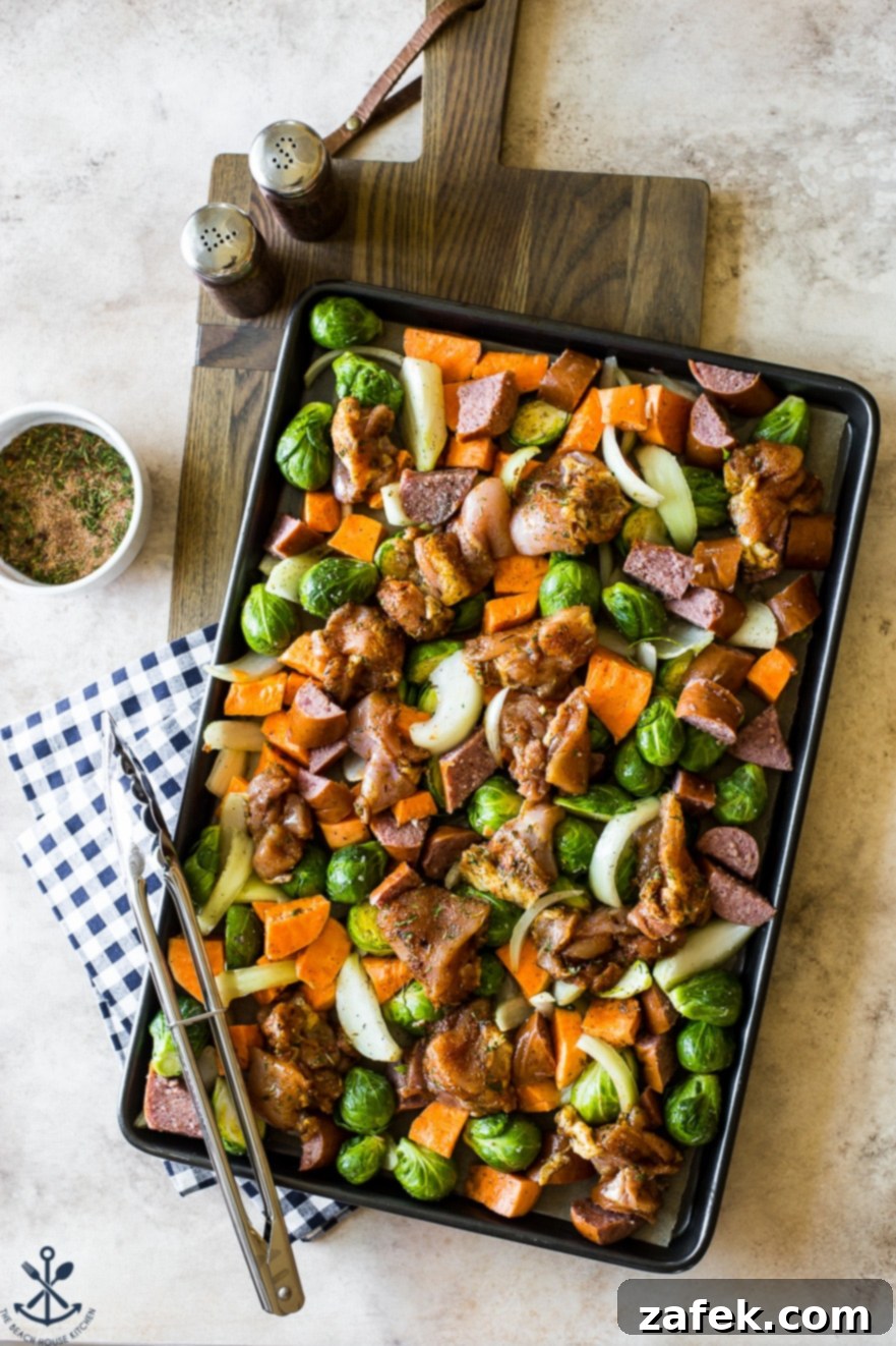 Overhead photo of the precooked jerk chicken sheet pan meal, vibrant and ready for the oven